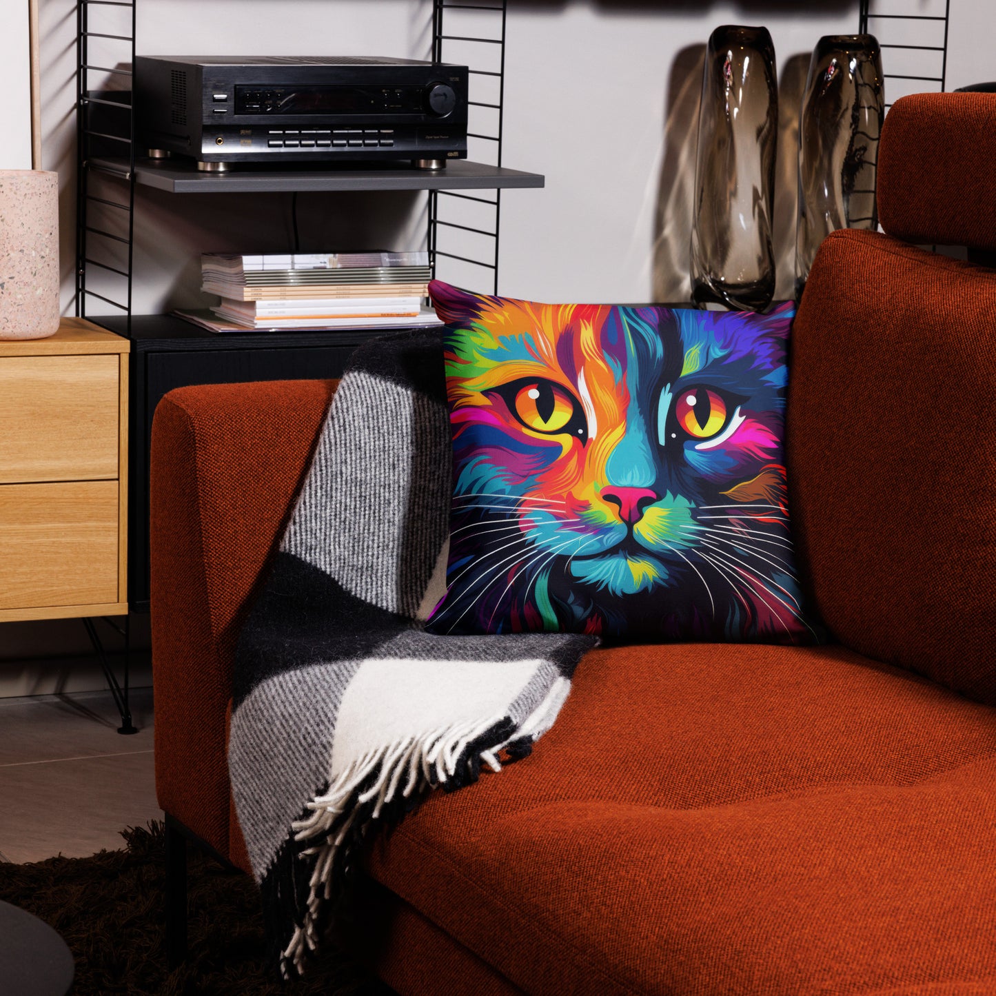 Bright neon cat throw pillow styled on couch in colorful living room